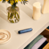 Ploom AURA front panel Navy Blue Augmented Pattern accessory on device, located on a table.
